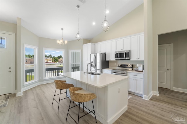 2098 Anna Ct, Milton, FL 32583 - kitchen featuring stainless steel appliances, a sink, an island with sink, a kitchen breakfast bar, and light wood finished floors