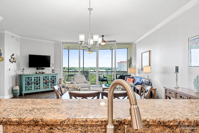 612 Lost Key Dr Unit 702-B, Pensacola, FL 32507 - living room featuring wood finished floors, ornamental molding, healthy amount of natural light, baseboards, and floor to ceiling windows