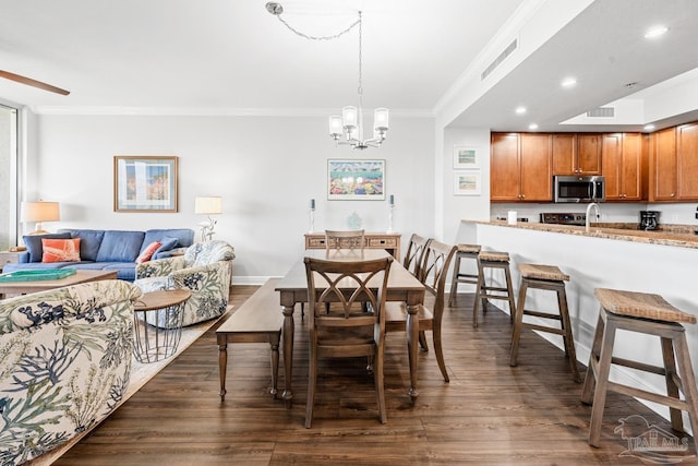 612 Lost Key Dr Unit 702-B, Pensacola, FL 32507 - dining space with ornamental molding, recessed lighting, dark wood-style flooring, a chandelier, and baseboards