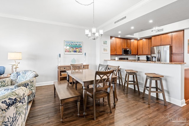 612 Lost Key Dr Unit 702-B, Pensacola, FL 32507 - dining space with ornamental molding, a chandelier, baseboards, dark wood-style floors, and recessed lighting