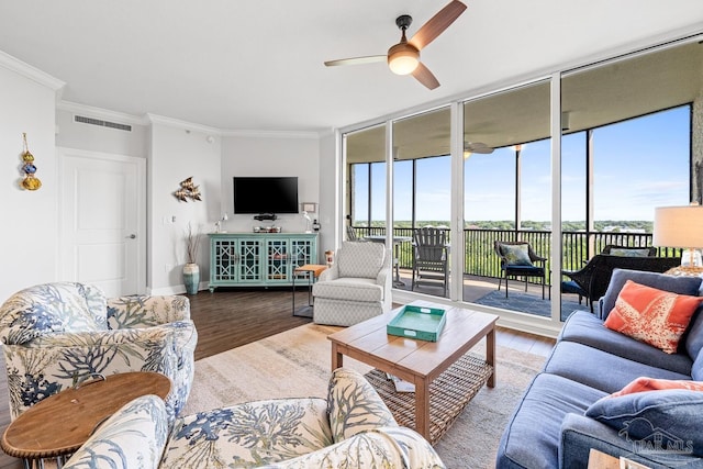 612 Lost Key Dr Unit 702-B, Pensacola, FL 32507 - living area featuring wood finished floors, a wall of windows, ceiling fan, ornamental molding, and baseboards