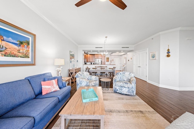 612 Lost Key Dr Unit 702-B, Pensacola, FL 32507 - living room featuring wood finished floors, ornamental molding, a chandelier, a ceiling fan, and baseboards