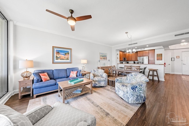 612 Lost Key Dr Unit 702-B, Pensacola, FL 32507 - living area with ornamental molding, a ceiling fan, wood finished floors, a chandelier, and baseboards