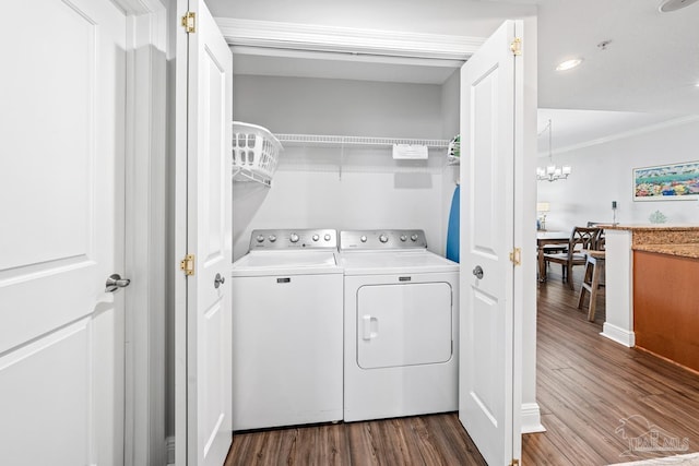 612 Lost Key Dr Unit 702-B, Pensacola, FL 32507 - laundry room with separate washer and dryer, dark wood-style floors, ornamental molding, and a chandelier