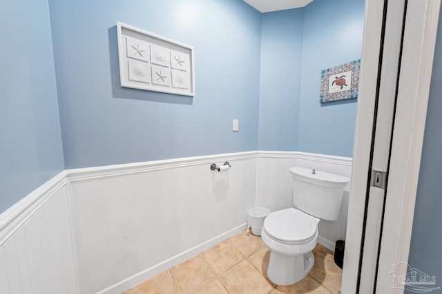 612 Lost Key Dr Unit 702-B, Pensacola, FL 32507 - bathroom with a wainscoted wall, toilet, and tile patterned floors