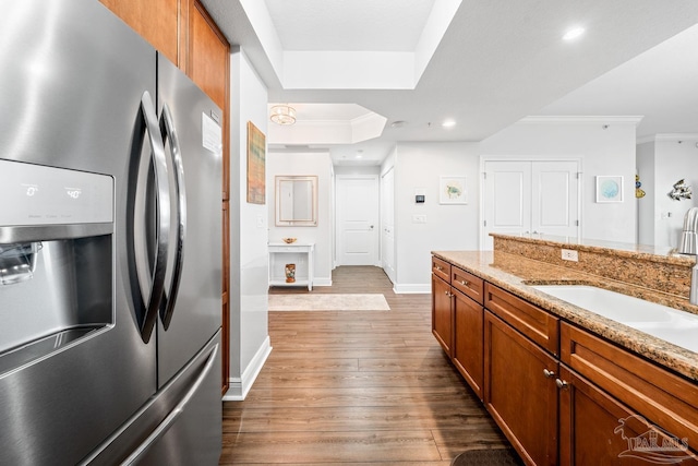 612 Lost Key Dr Unit 702-B, Pensacola, FL 32507 - kitchen featuring stainless steel refrigerator with ice dispenser, crown molding, brown cabinetry, baseboards, and dark wood-style flooring