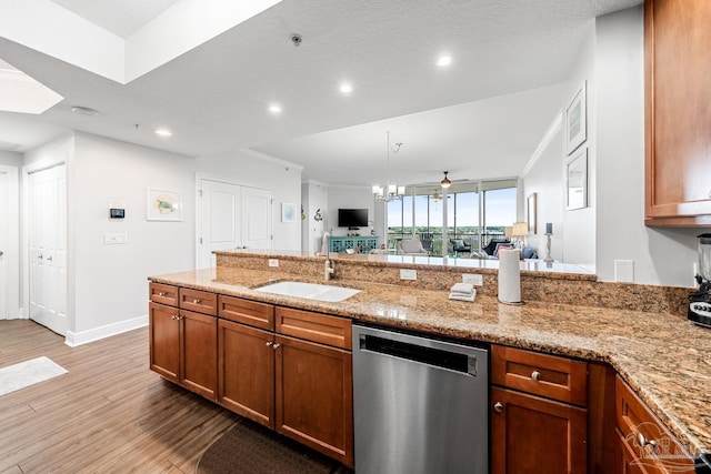 612 Lost Key Dr Unit 702-B, Pensacola, FL 32507 - kitchen with dishwasher, a sink, light wood finished floors, brown cabinets, and light stone countertops