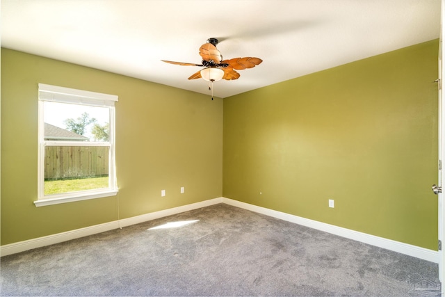 spare room with baseboards, carpet, and ceiling fan