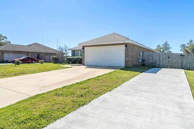 view of front facade with a front yard, a gate, driveway, an attached garage, and brick siding