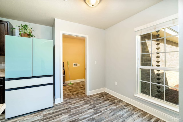 interior space with baseboards and wood finished floors