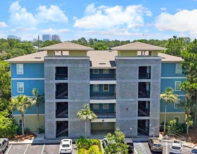 1430 Regency Rd Unit H103, Gulf Shores, AL 36542 - view of building exterior featuring uncovered parking