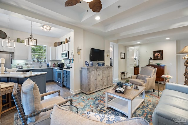 1430 Regency Rd Unit H103, Gulf Shores, AL 36542 - living area with recessed lighting, a ceiling fan, and a tray ceiling