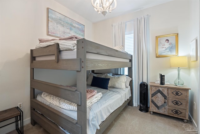 1430 Regency Rd Unit H103, Gulf Shores, AL 36542 - carpeted bedroom featuring a chandelier and baseboards