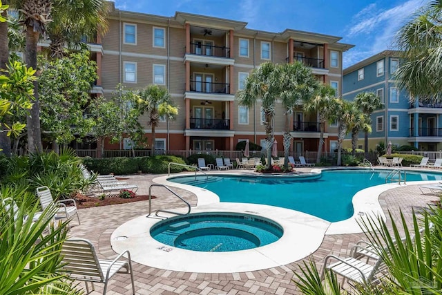 1430 Regency Rd Unit H103, Gulf Shores, AL 36542 - community pool featuring a community hot tub, a ceiling fan, and a patio area