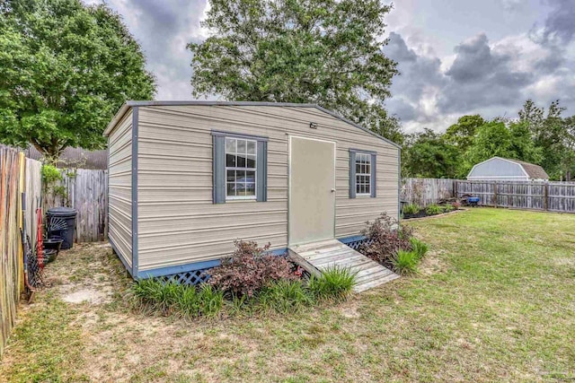 view of outbuilding with a fenced backyard and an outdoor structure