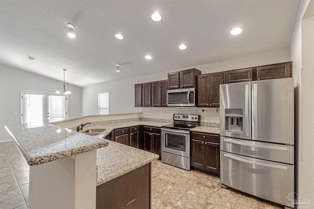 kitchen featuring kitchen peninsula, appliances with stainless steel finishes, dark brown cabinetry, vaulted ceiling, and hanging light fixtures