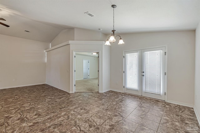 empty room with ceiling fan with notable chandelier and vaulted ceiling