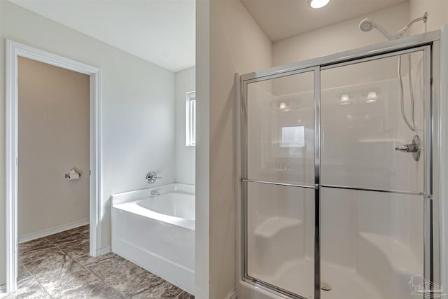 bathroom featuring independent shower and bath