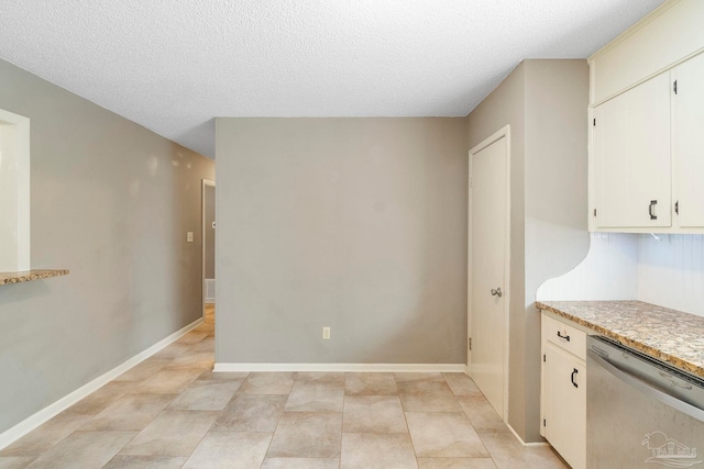 unfurnished dining area with light tile patterned floors and a textured ceiling