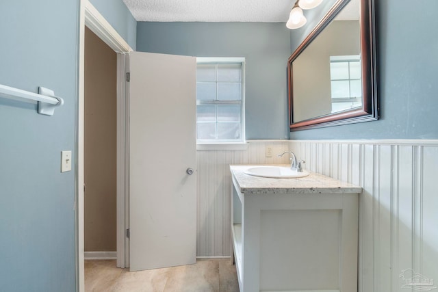 bathroom featuring vanity, a textured ceiling, and tile patterned flooring