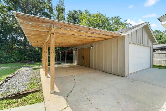 exterior space with a garage, an outbuilding, and a carport