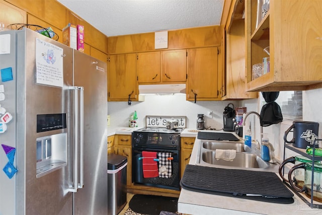 kitchen with under cabinet range hood, high quality fridge, light countertops, black range with electric stovetop, and a sink
