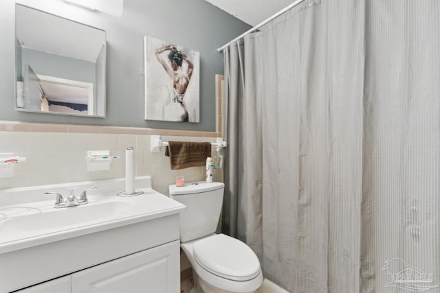 bathroom featuring wainscoting, vanity, curtained shower, and toilet