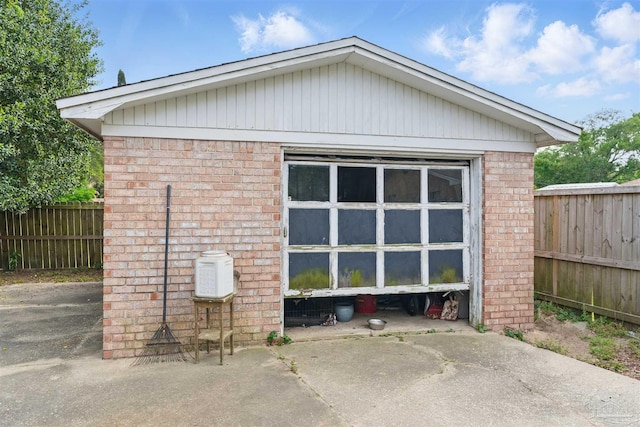 view of outbuilding featuring fence