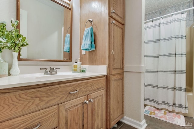 bathroom featuring tile patterned floors, vanity, a shower with curtain, and a textured ceiling