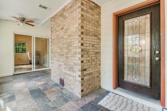 doorway to property featuring ceiling fan