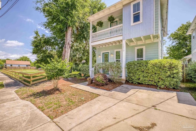 view of front of property with a balcony and a porch