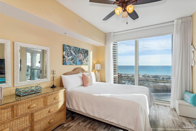 bedroom with a water view, access to outside, and ceiling fan