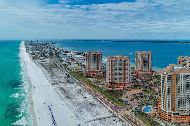 drone / aerial view featuring a water view and a view of the beach