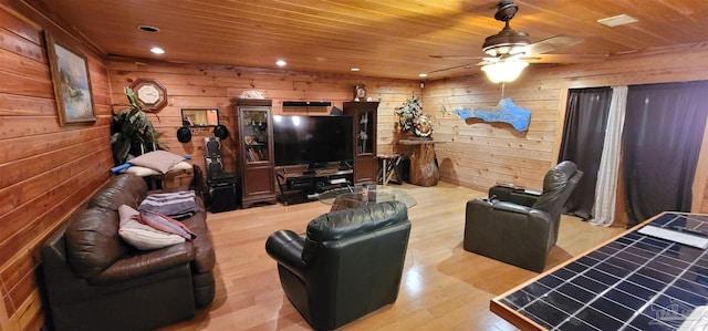 living room with wood walls, wooden ceiling, hardwood / wood-style flooring, and ceiling fan