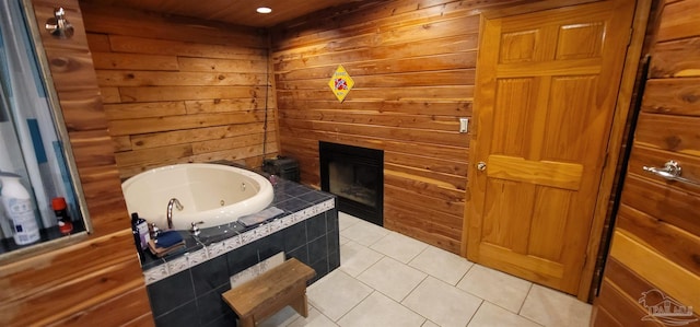 bathroom featuring tile patterned flooring and a tub to relax in