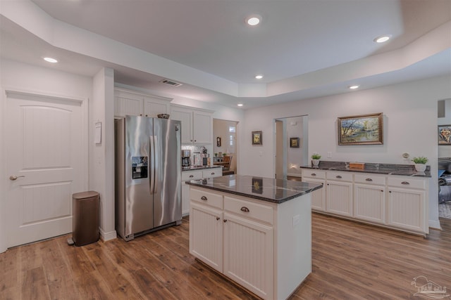 kitchen with recessed lighting, dark wood-style flooring, stainless steel refrigerator with ice dispenser, and visible vents
