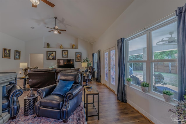 living room with a ceiling fan, vaulted ceiling, wood finished floors, and visible vents