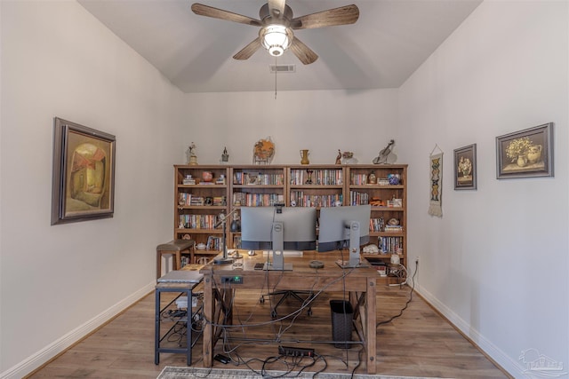 office space with a ceiling fan, baseboards, visible vents, and wood finished floors