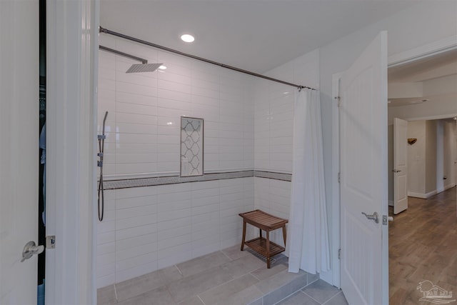 full bathroom featuring recessed lighting and tiled shower