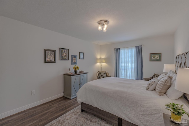 bedroom featuring baseboards and wood finished floors