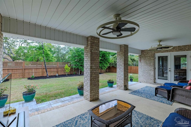 view of patio / terrace with ceiling fan, french doors, and a fenced backyard