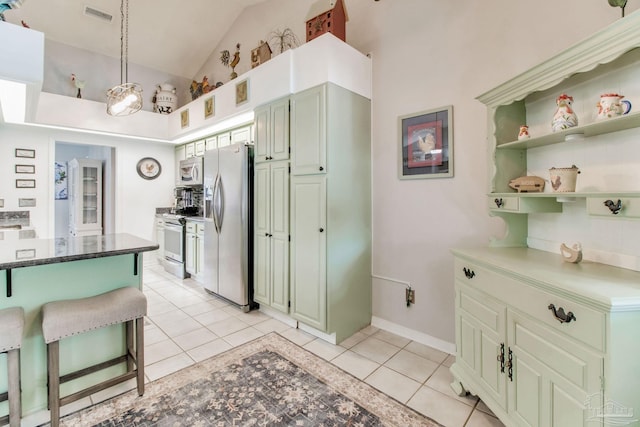 905 Shadow Ridge Dr, Pensacola, FL 32514 - kitchen with stainless steel appliances, light tile patterned flooring, lofted ceiling, a kitchen breakfast bar, and open shelves