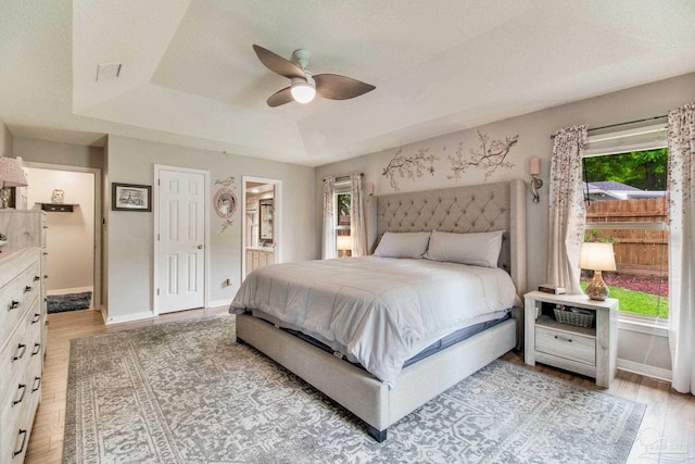 905 Shadow Ridge Dr, Pensacola, FL 32514 - bedroom featuring a raised ceiling, light wood-type flooring, baseboards, and connected bathroom