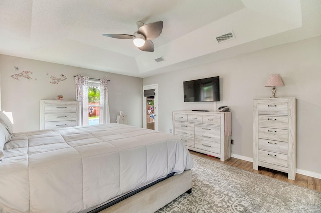 905 Shadow Ridge Dr, Pensacola, FL 32514 - bedroom with a raised ceiling, light wood-style floors, ceiling fan, access to outside, and baseboards