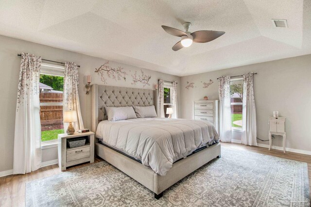 905 Shadow Ridge Dr, Pensacola, FL 32514 - bedroom with multiple windows, light wood finished floors, baseboards, and a textured ceiling