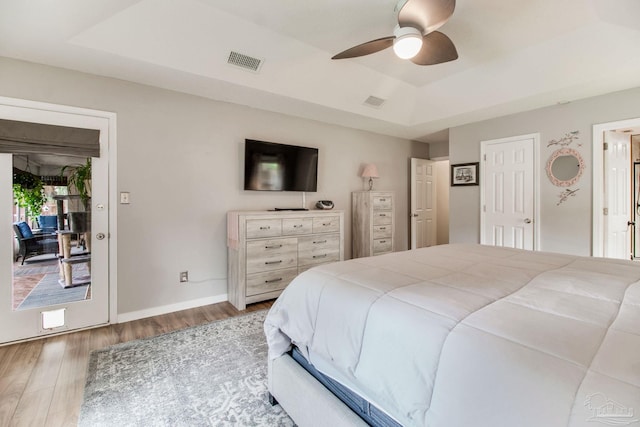 905 Shadow Ridge Dr, Pensacola, FL 32514 - bedroom featuring a raised ceiling, wood finished floors, access to exterior, a ceiling fan, and baseboards