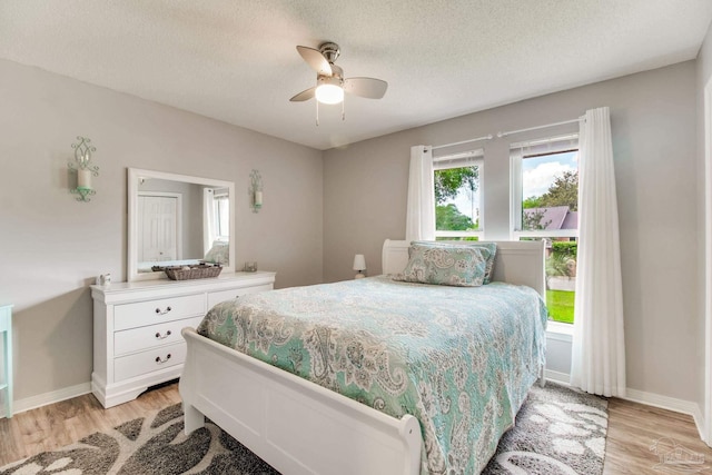 905 Shadow Ridge Dr, Pensacola, FL 32514 - bedroom with light wood-type flooring, a textured ceiling, baseboards, and ceiling fan