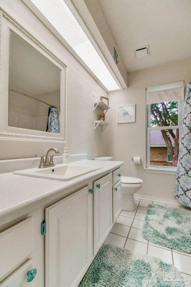 905 Shadow Ridge Dr, Pensacola, FL 32514 - bathroom with toilet, tile patterned flooring, vanity, baseboards, and a shower with shower curtain