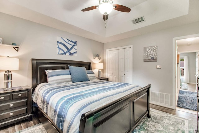 905 Shadow Ridge Dr, Pensacola, FL 32514 - bedroom featuring wood finished floors, a closet, a tray ceiling, a ceiling fan, and baseboards