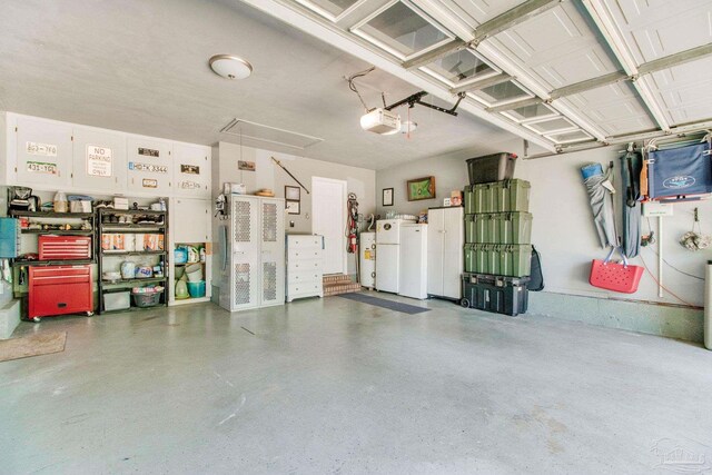 905 Shadow Ridge Dr, Pensacola, FL 32514 - garage featuring freestanding refrigerator, a garage door opener, and water heater